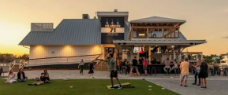 Bachelorette group sharing drinks and food at a Front Beach patio on Isle of Palms