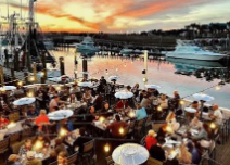 Bachelorette group at a dockside dinner table on Shem Creek